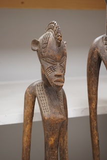 Three African tribal figural carvings including one Dogon maternity figure, largest 82cm. Condition - some cracking